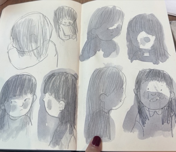 Eight small heads — pencil and ink wash, a sketchbook spread